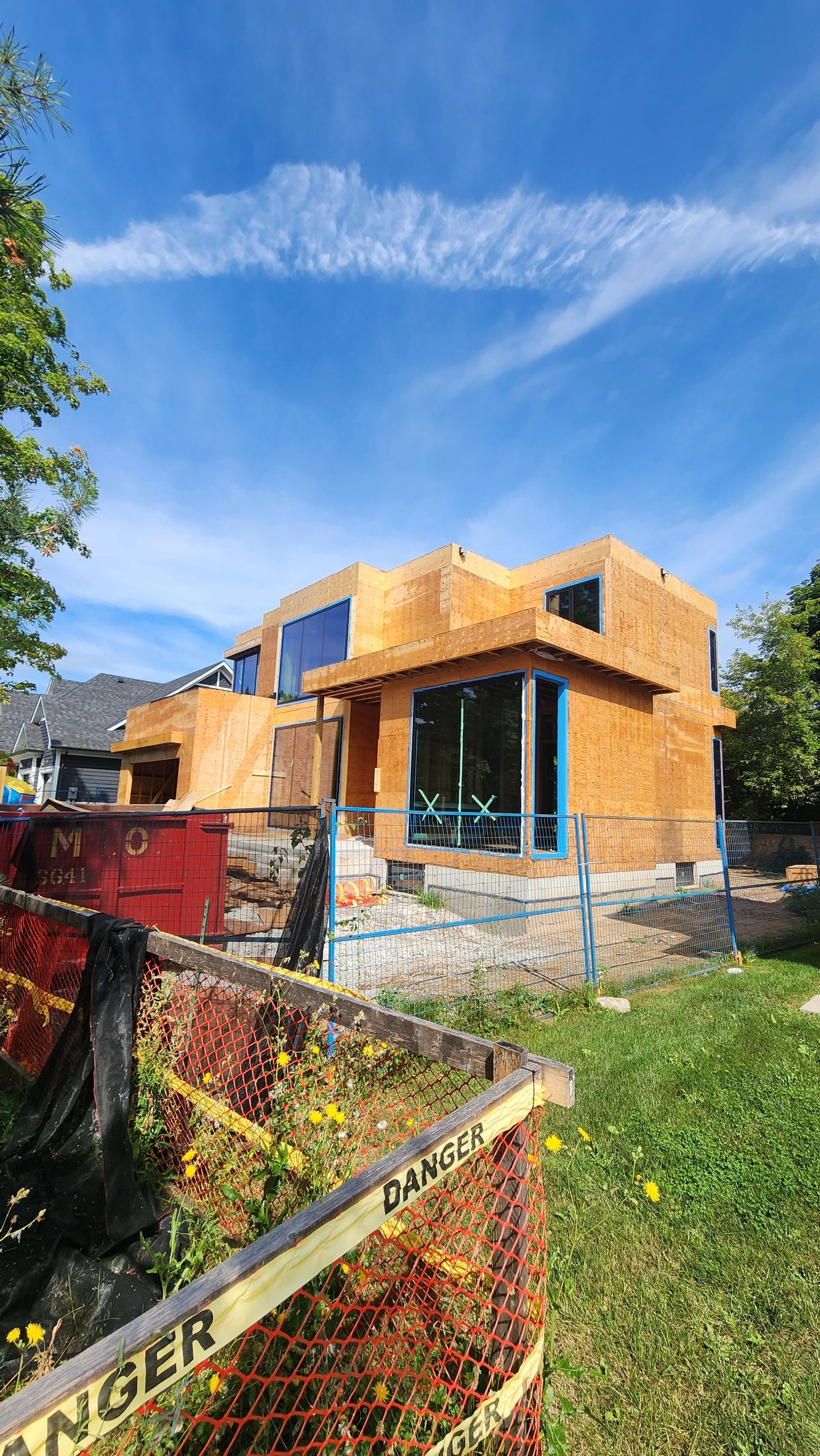 Modern home with orange brick and blue windows