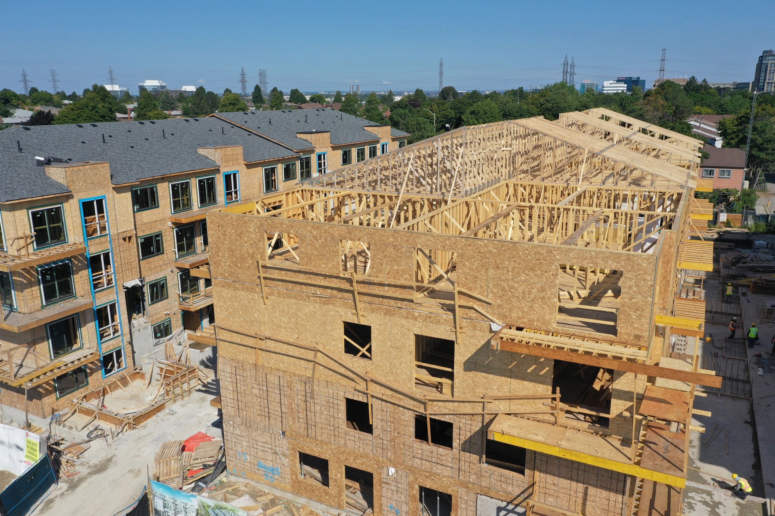 Aerial construction site with residential framing and roof trusses