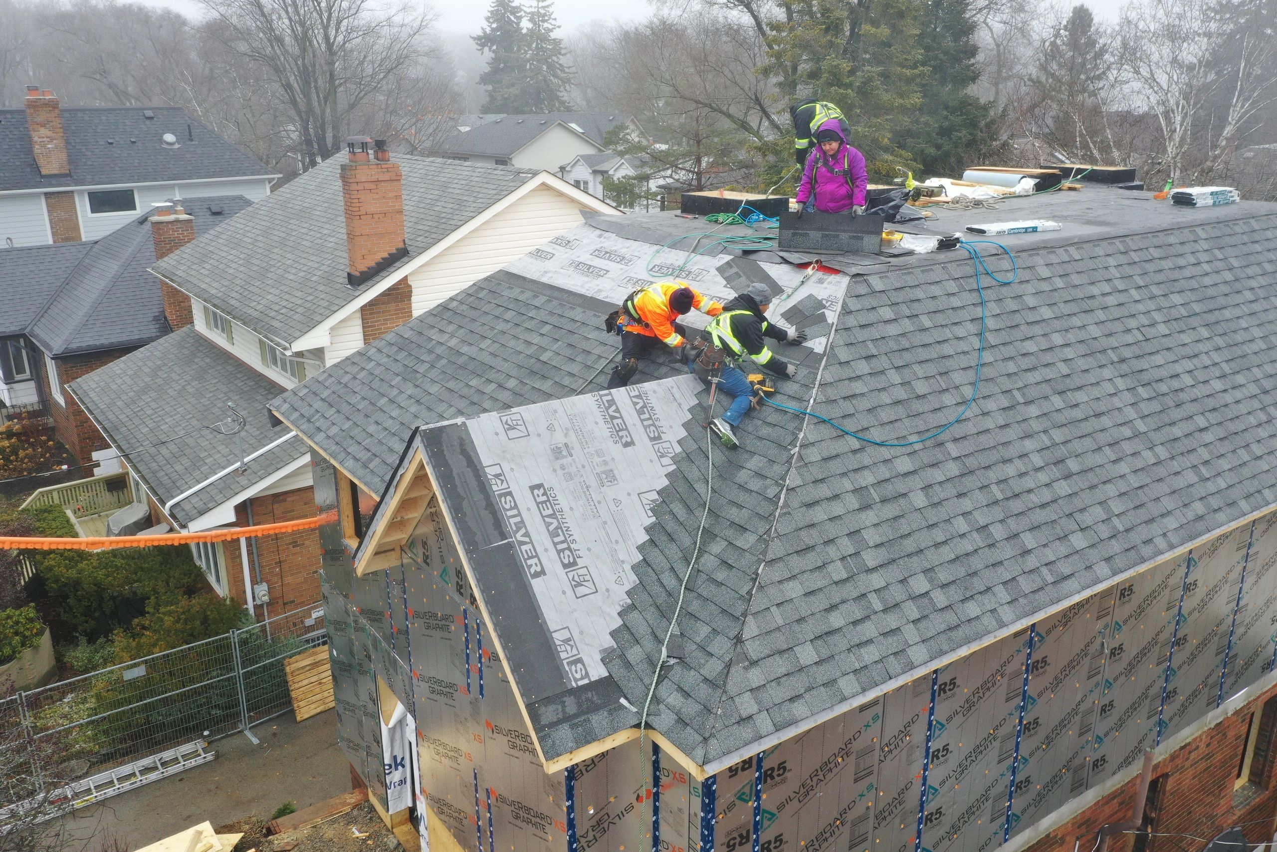 Residential roofing workers with safety gear